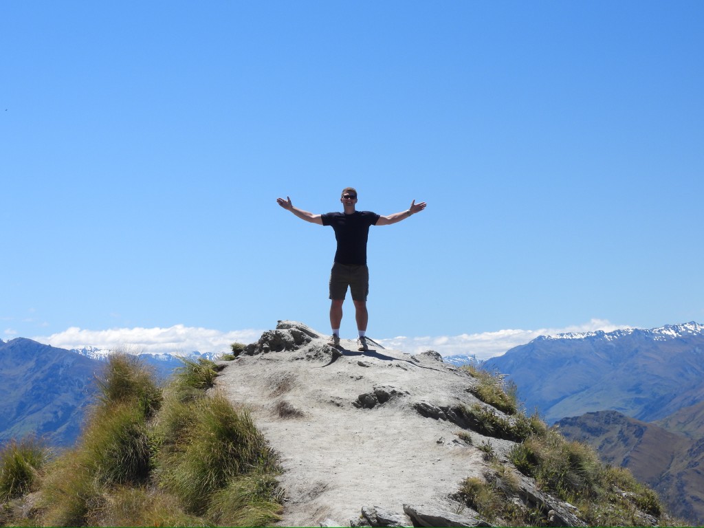 Alan standing on the summit of Roy's Peak with arms outstretched